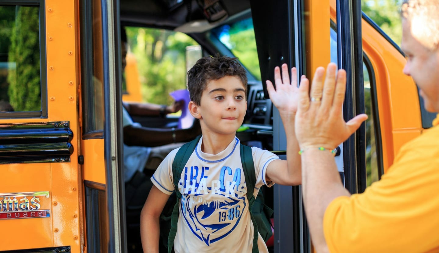 Kids riding the bus to camp