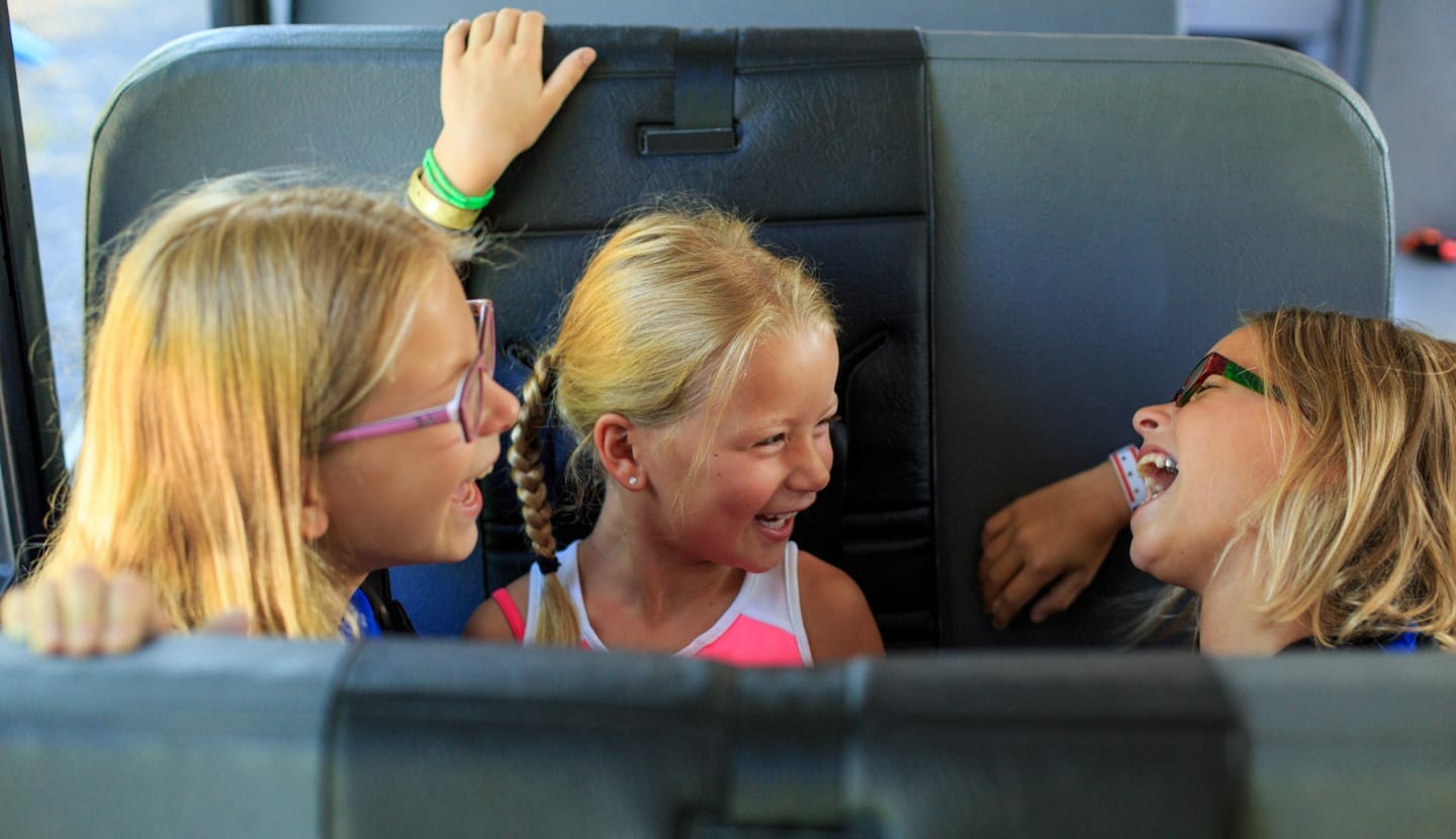 Kids riding the bus to camp