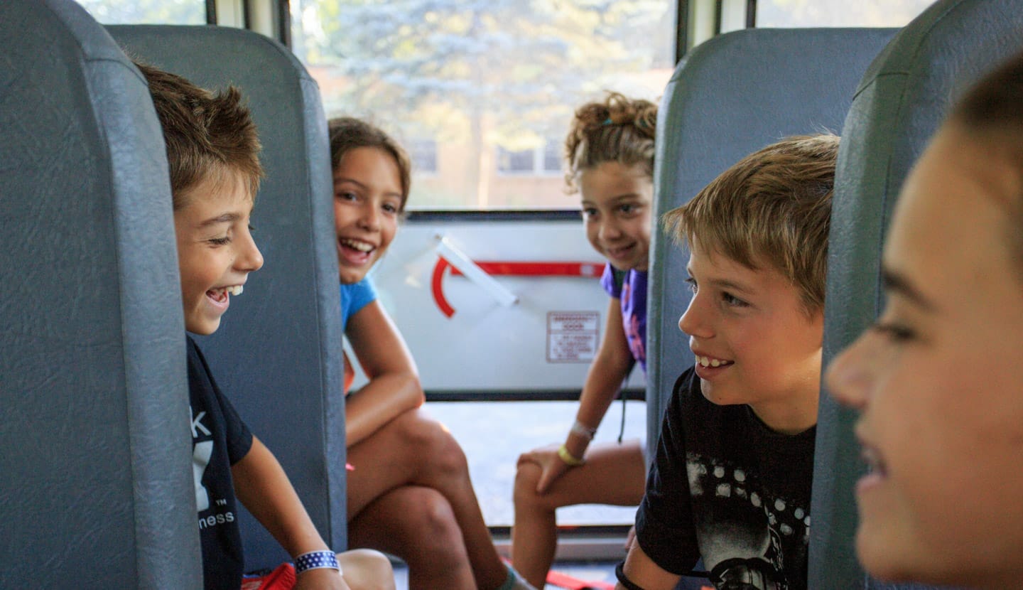 Kids riding the bus to camp